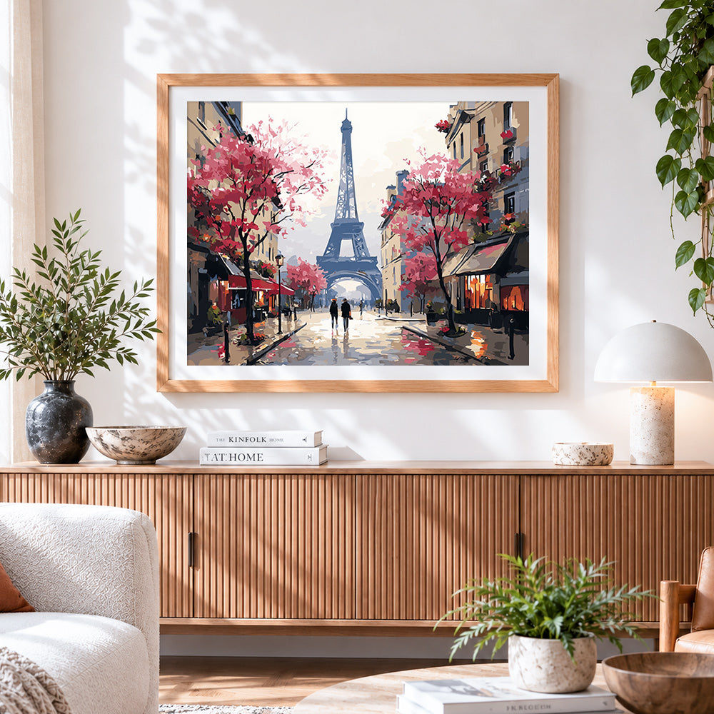 Finished majestic eiffel tower with pink blossoms cross stitch artwork displayed