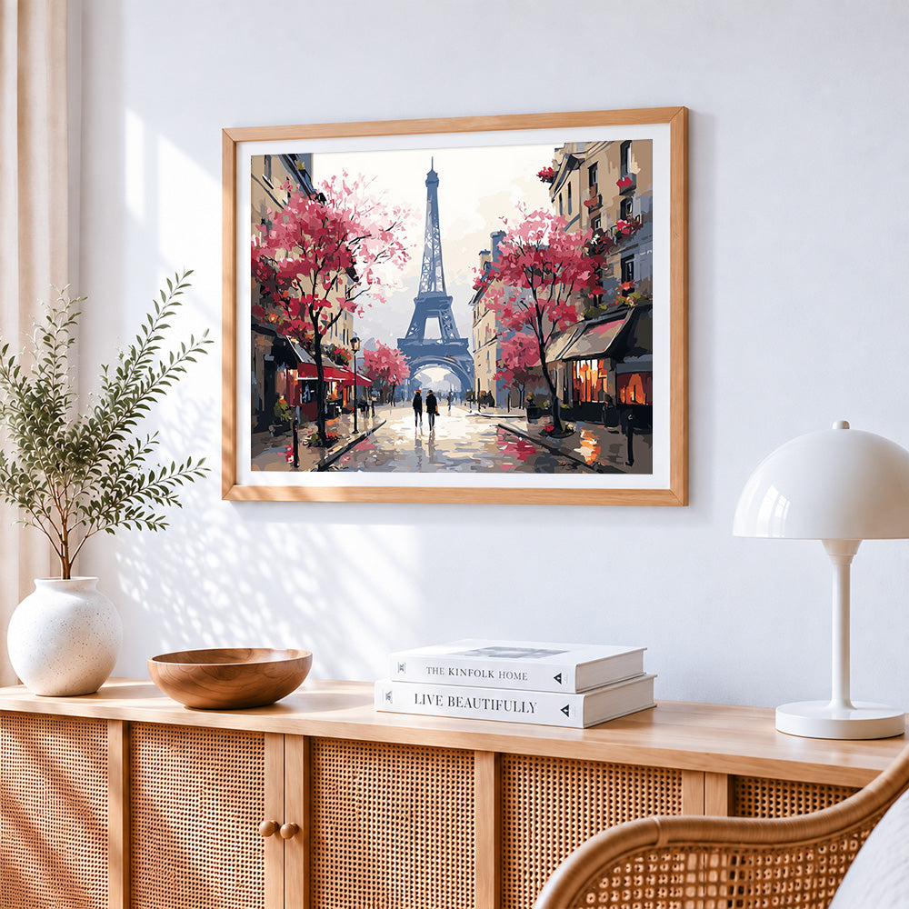 Majestic eiffel tower with pink blossoms cross stitch artwork displayed on wall as home decor