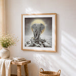 Majestic elephant with golden halo cross stitch artwork displayed on wall as home decor