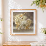 Finished majestic golden unicorn in mist cross stitch artwork displayed