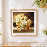 Finished majestic golden unicorn with flowing mane cross stitch artwork displayed