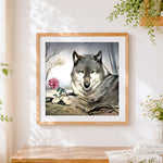 Finished majestic grey wolf and pink rose cross stitch artwork displayed