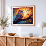 Majestic owl in autumn sunset cross stitch artwork displayed on wall as home decor