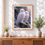 Finished majestic snowy owls in winter forest cross stitch artwork displayed