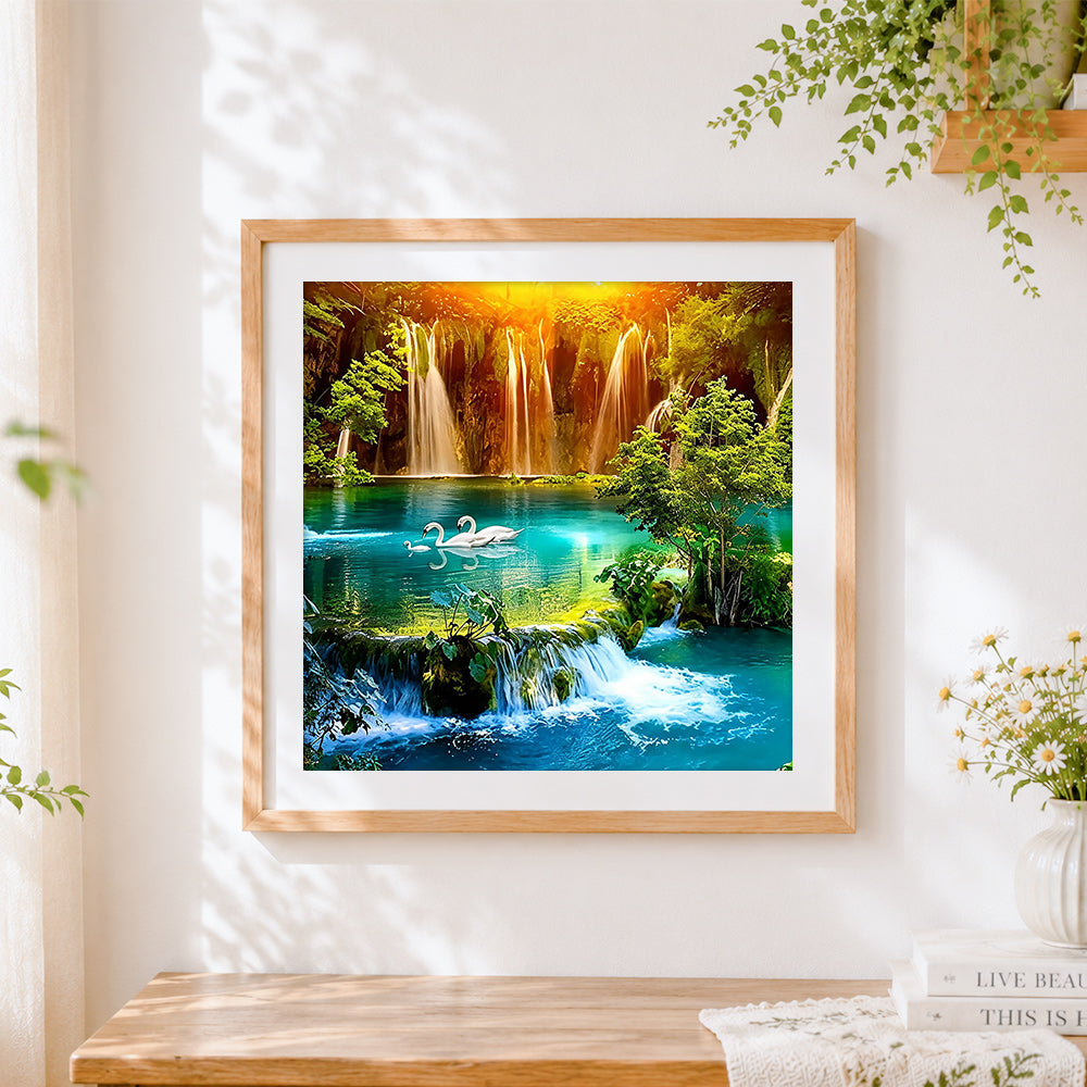 Finished majestic waterfalls with swimming swans cross stitch artwork displayed