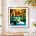 Finished majestic waterfalls with swimming swans cross stitch artwork displayed