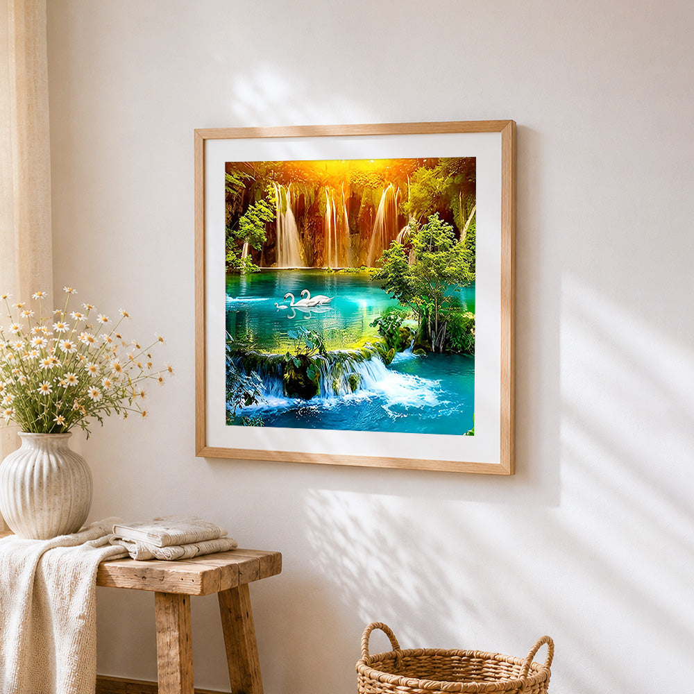 Majestic waterfalls with swimming swans cross stitch artwork displayed on wall as home decor
