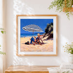 Finished man and dog relaxing on beach cross stitch artwork displayed