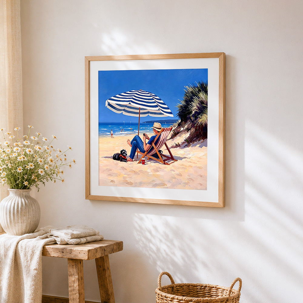 Man and dog relaxing on beach cross stitch artwork displayed on wall as home decor