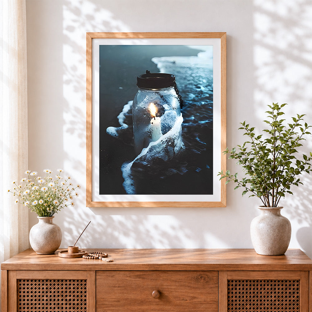 Finished mason jar candle in ocean waves cross stitch artwork displayed