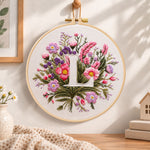 Mauve wildflowers and letter l embroidery hoop wall art displayed as warm and cosy handmade home decor