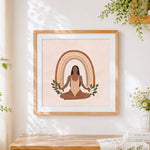 Finished meditating woman with boho rainbow cross stitch artwork displayed