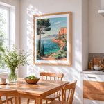 Mediterranean cliffside and sailboat cross stitch artwork displayed on wall as home decor
