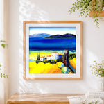 Finished mediterranean white village cross stitch artwork displayed