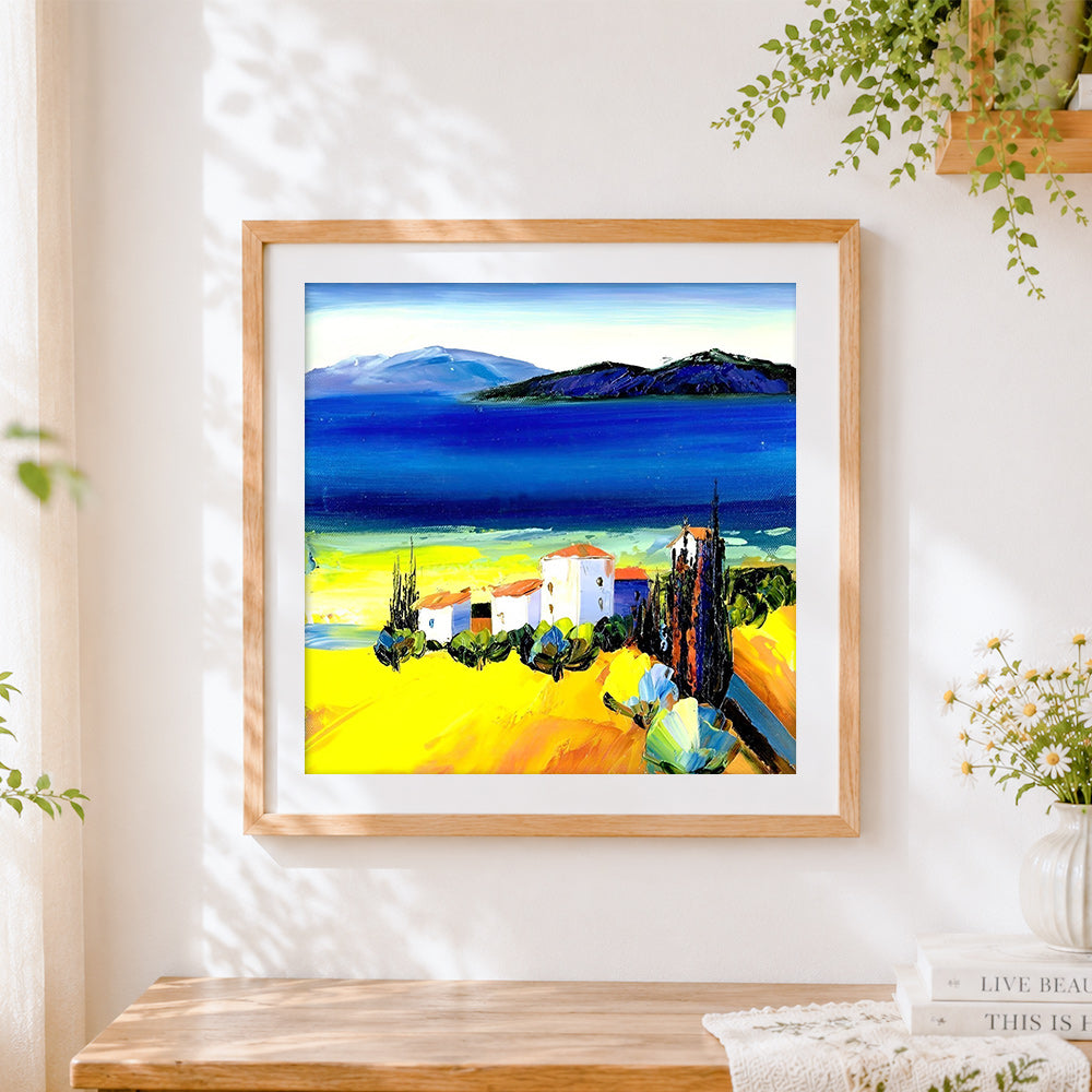 Finished mediterranean white village cross stitch artwork displayed