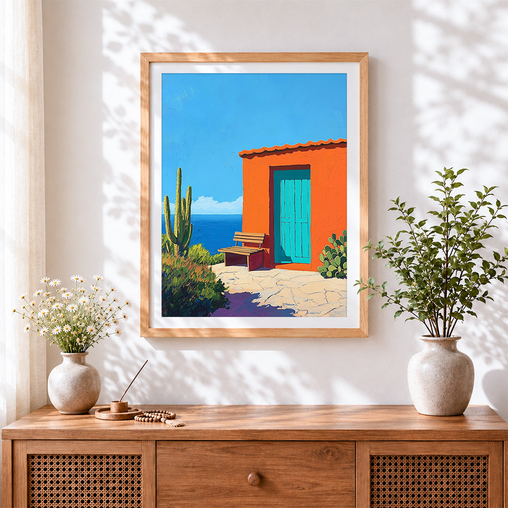 Finished mexican orange casita and cactus cross stitch artwork displayed