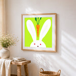 Minimalist bunny and carrot cross stitch artwork displayed on wall as home decor