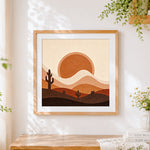 Finished minimalist desert sunset and cactus cross stitch artwork displayed