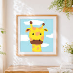 Finished minimalist giraffe face cross stitch artwork displayed