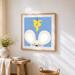 Minimalist mouse and cheese cross stitch artwork displayed on wall as home decor