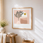 Minimalist olive tree and sun cross stitch artwork displayed on wall as home decor