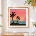 Finished minimalist palm tree sunset cross stitch artwork displayed