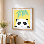 Minimalist panda face cross stitch artwork displayed on wall as home decor