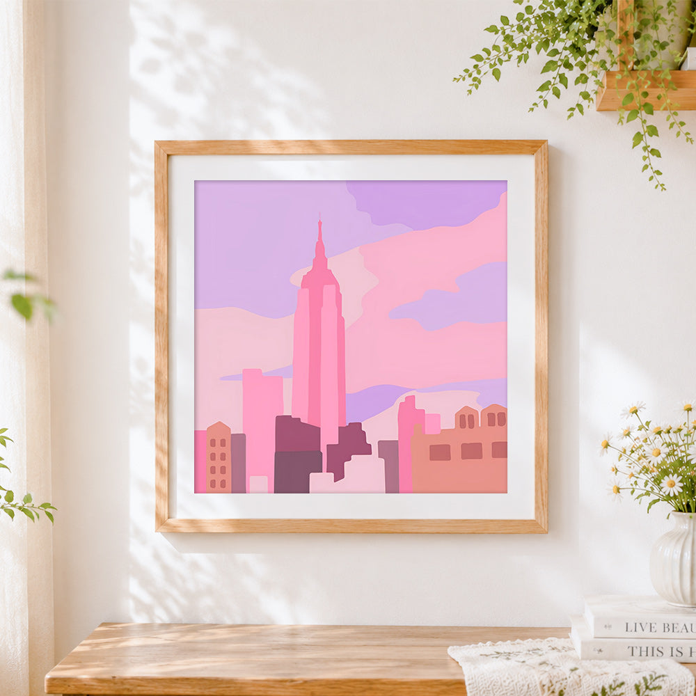 Finished minimalist pink city skyline cross stitch artwork displayed