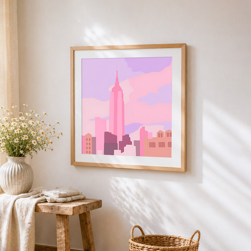 Minimalist pink city skyline cross stitch artwork displayed on wall as home decor