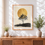 Finished minimalist tree and golden sun cross stitch artwork displayed