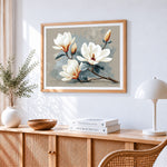 Minimalist white magnolia branch cross stitch artwork displayed on wall as home decor