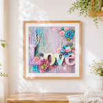 Finished mixed media love floral collage cross stitch artwork displayed