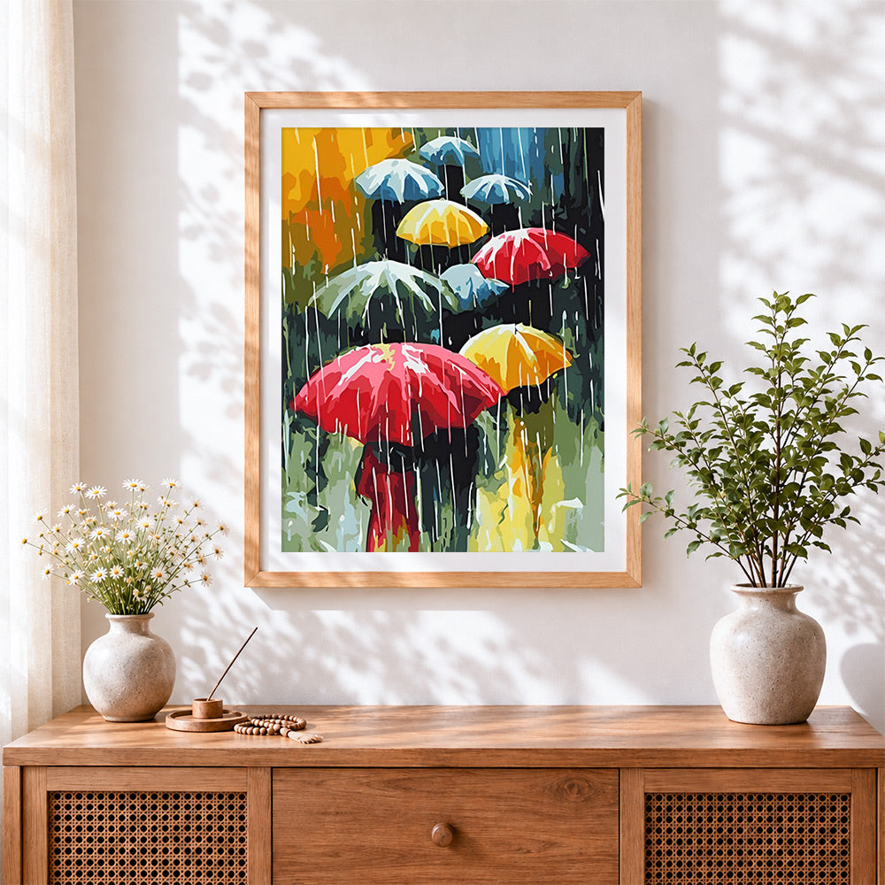 Finished modern colourful umbrellas in rain cross stitch artwork displayed