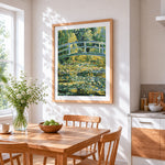 Monet style water lily pond and bridge cross stitch artwork displayed on wall as home decor