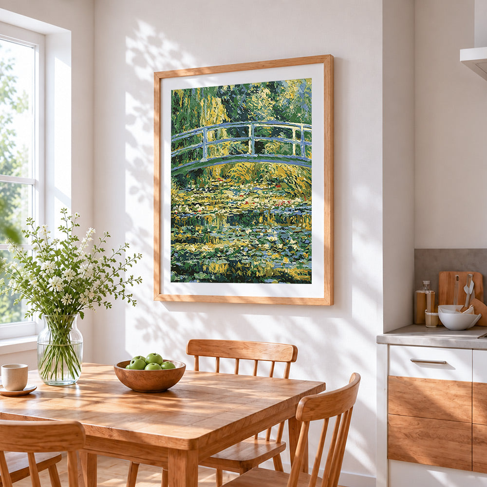 Monet style water lily pond and bridge cross stitch artwork displayed on wall as home decor