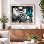 Finished monochrome cat and green butterfly cross stitch artwork displayed