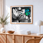 Monochrome cat and green butterfly cross stitch artwork displayed on wall as home decor