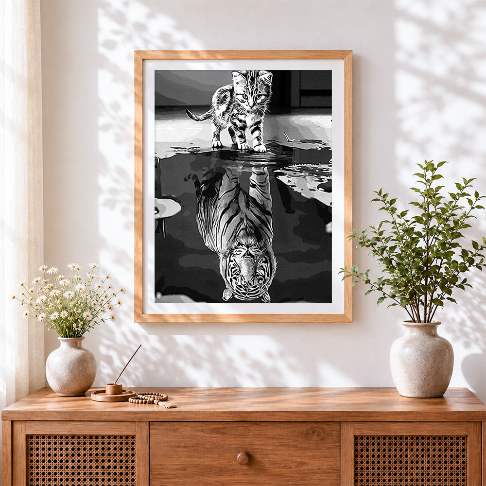 Finished monochrome cat and tiger reflection cross stitch artwork displayed