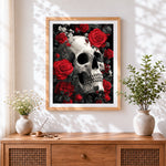 Finished monochrome skull with red roses cross stitch artwork displayed