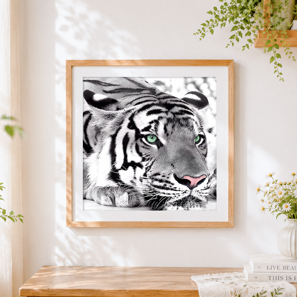 Finished monochrome tiger with green eyes cross stitch artwork displayed