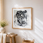 Monochrome white tiger portrait cross stitch artwork displayed on wall as home decor