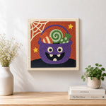 Finished monster candy bucket artwork displayed on a wall