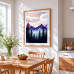 Moon over pine trees and mountains cross stitch artwork displayed on wall as home decor