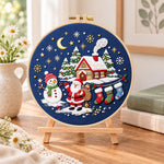 Moonlight christmas scene embroidery kit finished hoop displayed on a wooden stand as cosy tabletop decor