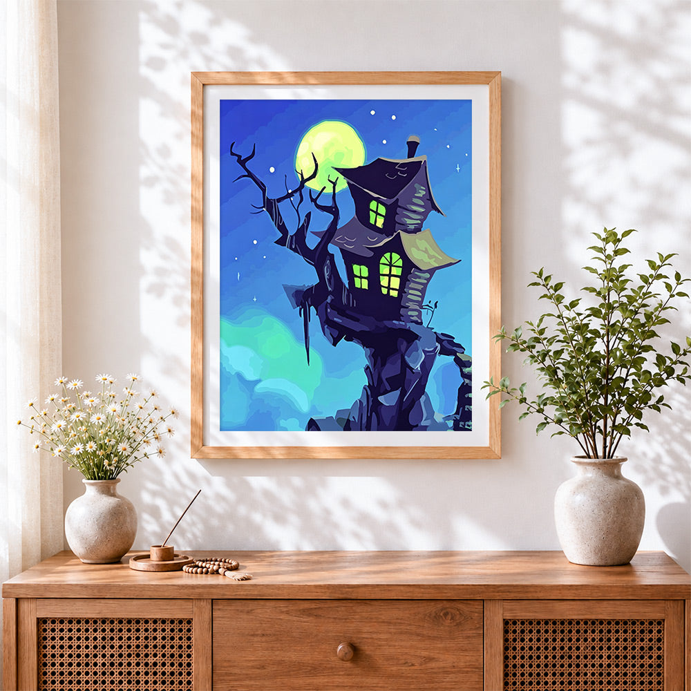 Finished moonlit haunted house cross stitch artwork displayed