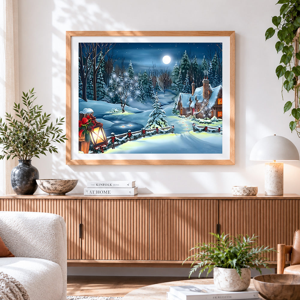 Finished moonlit snowy cottage with festive lanterns cross stitch artwork displayed