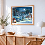 Moonlit snowy cottage with festive lanterns cross stitch artwork displayed on wall as home decor