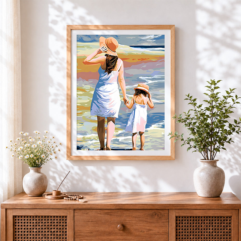 Finished mother and daughter walking to the sea cross stitch artwork displayed
