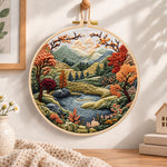 Mountain lake autumn landscape embroidery hoop wall art displayed as warm and cozy handmade home decor