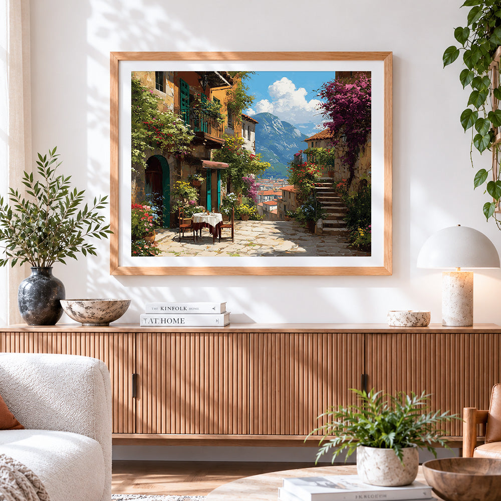 Finished mountain village and al fresco dining cross stitch artwork displayed